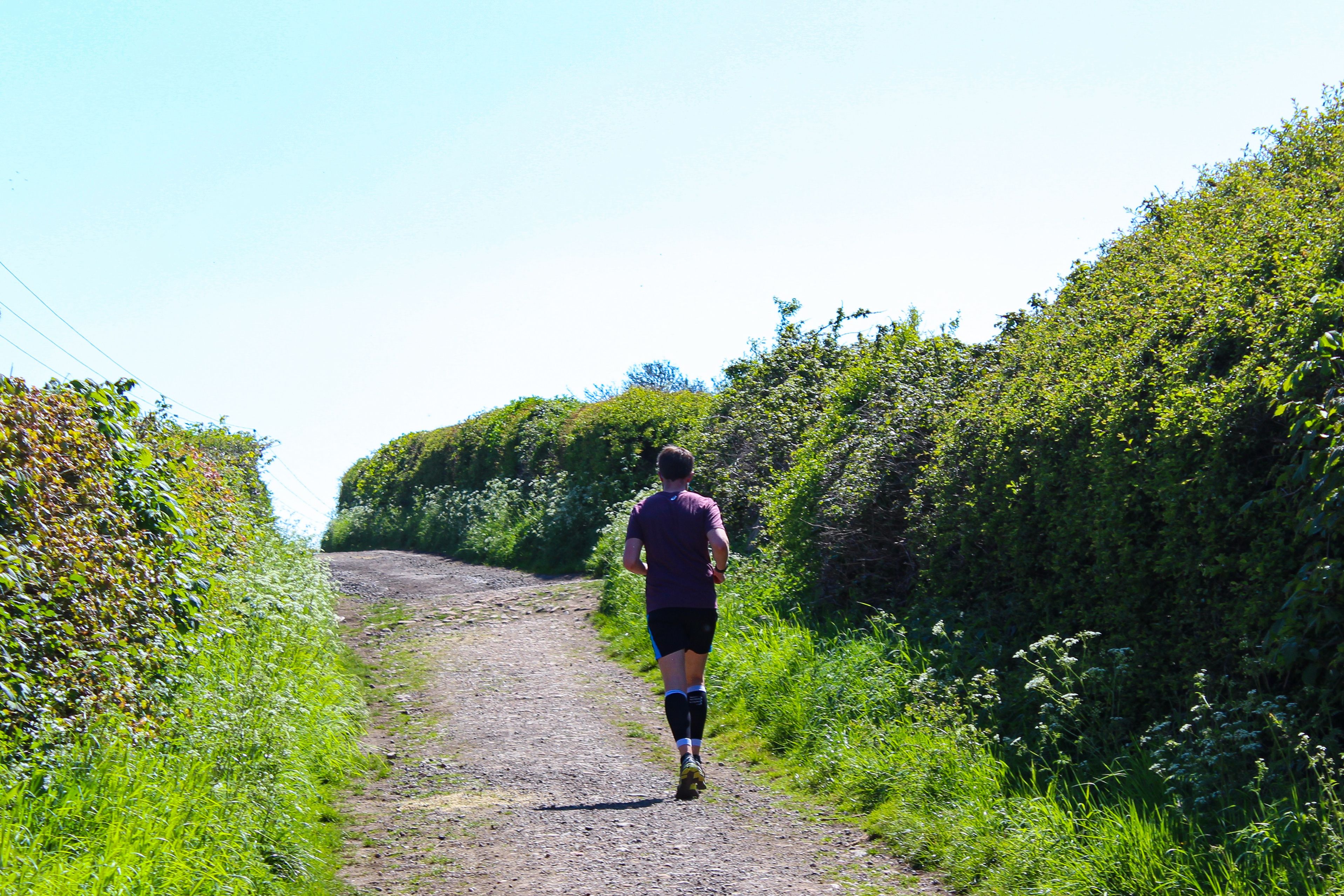 man running down a country road