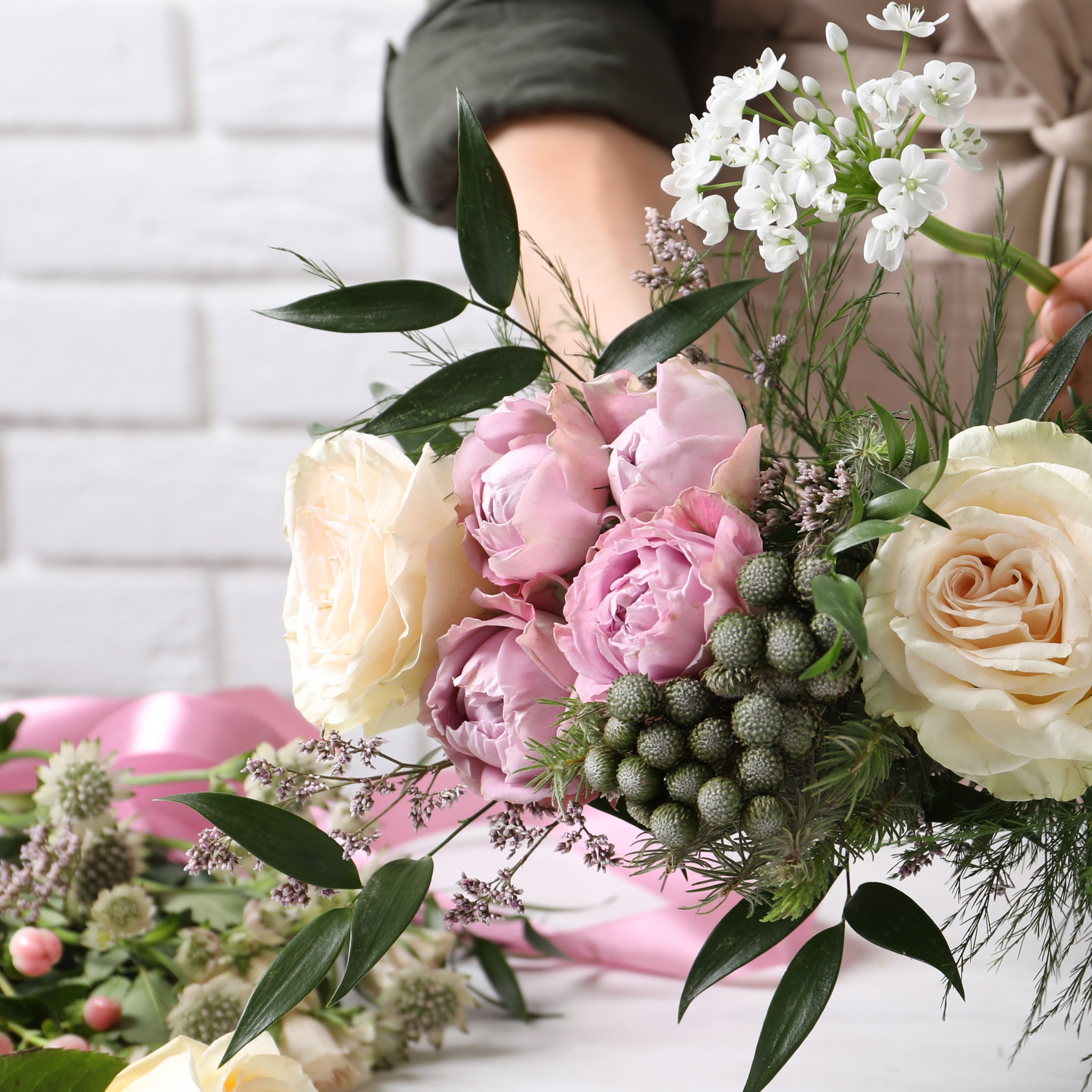 fresh flower and foliage wreath in pink, white and cream flowers.
