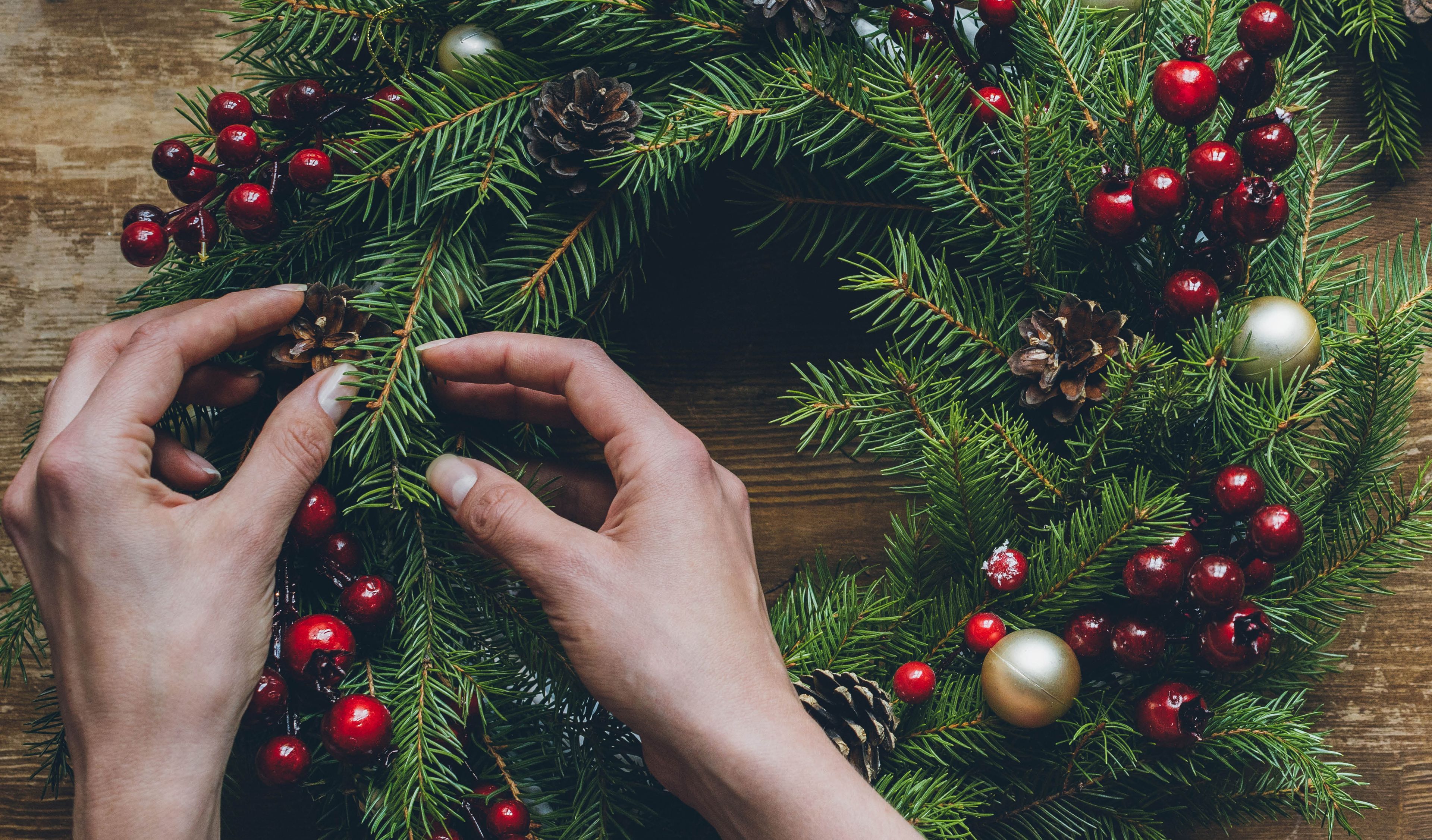 Christmas wreath making with red currants and gold baubles